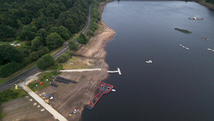 Aerial View of Ladybower Reservoir Shoreline with Docks and Winding Road © blueringmedia