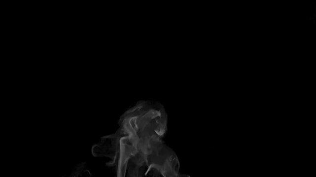 Traditional Arabic incense (Oud) smoke rising from a glass burner in slow motion.