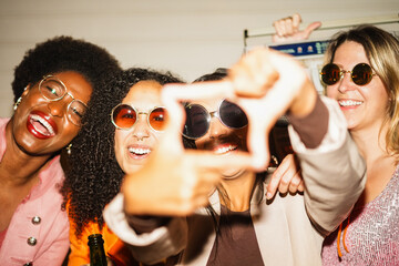 Crazy women friends having fun at night time listening music outdoor - Party, nightlife and people...