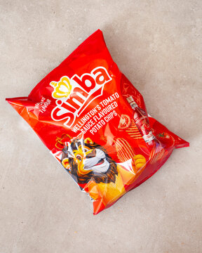 Simba Wellingtons tomato sauce flavored potato chips packet on neutral background South Africa editorial