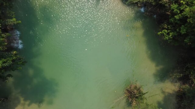 A drone view overlooking the famous Kuan Si Waterfall in Laos