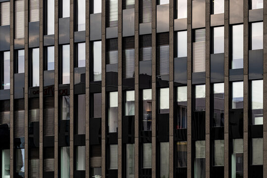 Vertical windows across a facade set pattern lines and texture in modern architecture creating abstract background for publishing design layouts