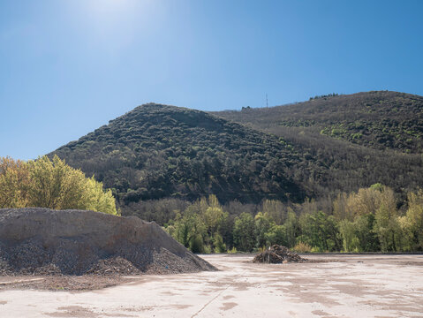 The last pile of rubble stands out on the concrete esplanade of the old warehouse, abandoned after its demolition next to the Sil River in Ponferrada, at the foot of the Pajariel peak