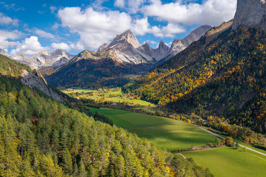 Autumn aerial view of Vallon de la Jarjatte in Vercors Regional Natural Park. Peaks of the Devoluy massif with colorful forest, Drome, France