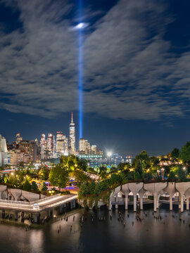 Little Island at night with the Tribute in Light September 11 memorial spotlight beams and Lower Manhattan skyline in New York City, USA