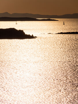 Yacht at sunset in the Aegean Sea on Mykonos island in Greece