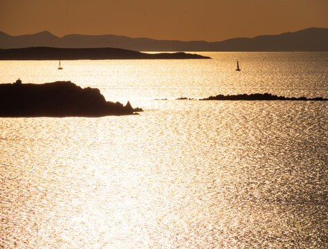 Yacht at sunset in the Aegean Sea on Mykonos island in Greece