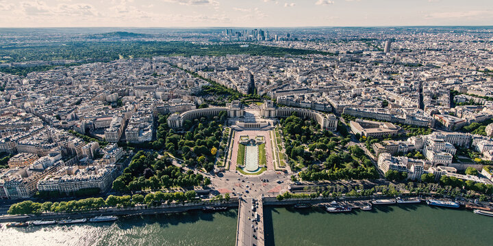 Aerial view of the Palais de Chaillot and Trocadero gardens overlooking the Seine river and the dense urban landscape of Paris, Ile-de-France, France.