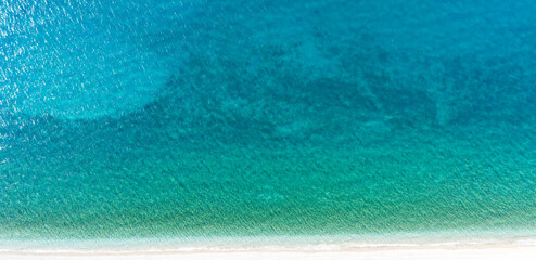 Obraz premium Beautiful drone top down of calm turquoise waves gently rolling onto a sandy beach
