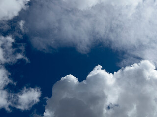 Obraz premium Blue sky with large white clouds. Open cloudscape in daylight. Natural weather background and copy space..