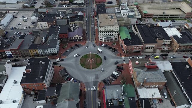Lincoln Square circular hub connects York Street Carlisle Street with dense historic storefronts surrounding intersection, textures, parked vehicles, crisp afternoon highlights. Gettysburg, PA
