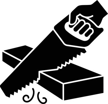 Hand holding a saw cutting through a wood block