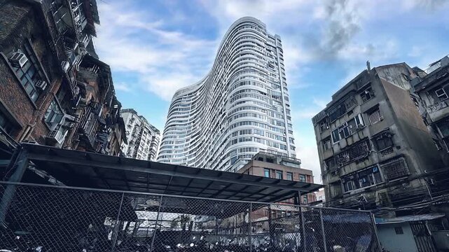 Modern Curved Skyscraper Rising Above Narrow Urban Alley Under Cloudy Sky seemles looping Video 4 K quality 