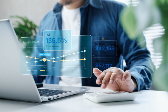 Business professional analyzing ROI performance and payback period on financial dashboard overlay using laptop and calculator in modern workspace, investment strategy and profit growth concept