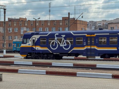Khmelnytskyi, Ukraine - March 30, 2026: Ukrzaliznytsia train at station with large bicycle graphic on carriage, promoting eco-friendly passenger transport and cycling culture