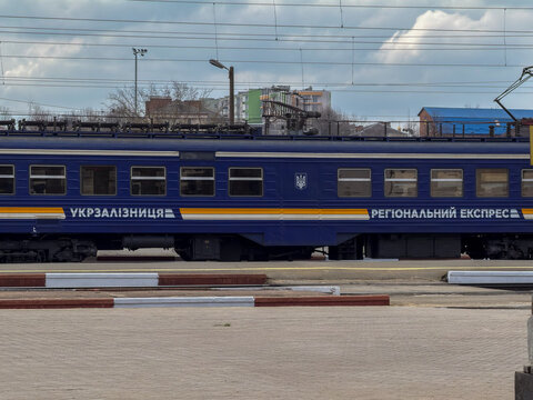 Khmelnytskyi, Ukraine - March 30, 2026: An Ukrzaliznytsia passenger train carriage stands at a railway station platform, highlighting key public transit infrastructure now