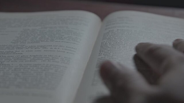 Close up of book pages turning in an old book, capturing the essence of reading, learning, and classic literature in a detailed visual.