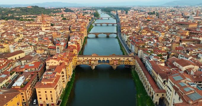 Majestic Florence Italy unique urban architecture riverside. Famous Ponte Vecchio bridge scenic Arno river landscape summer evening. Travel tourism destination exploration landscape high angle.
