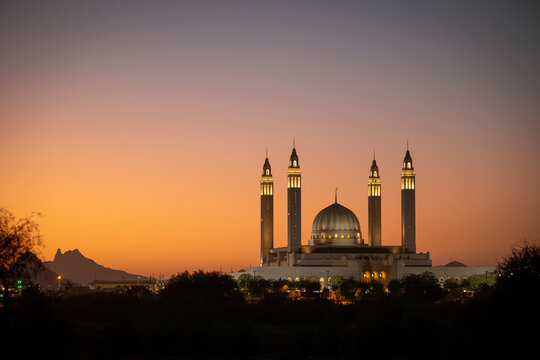 Nizwa Sultan Qaboos Mosque in Oman with sunset in the background