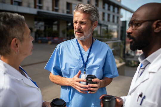 Medical team talking during coffee break outside hospital