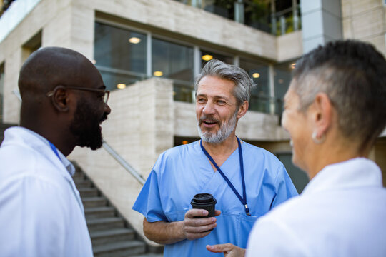 Doctors chatting during coffee break outside hospital