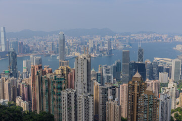 Fototapeta premium 20 April 2026 View of Residential and Commercial buildings and Victoria Harbour in Hong Kong HK in china. The Blue Skies and blue harbour is so Beautiful with view of Tsim Tsa Tsui commercial CBD Dist