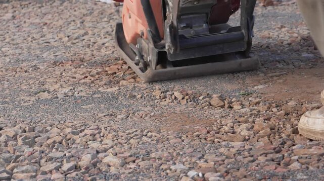 Plate compactor on gravel close-up