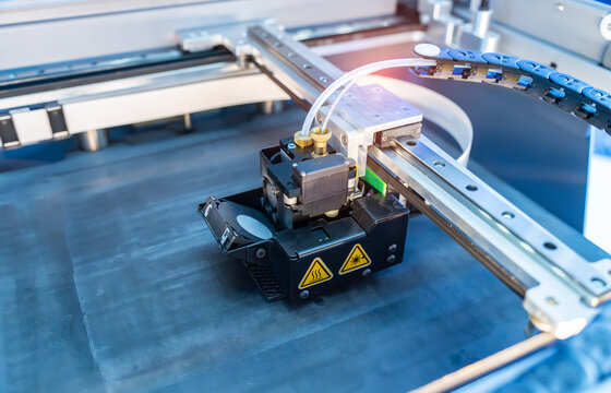 A sophisticated Carbon Fiber 3D printer is in operation, meticulously producing intricate carbon fiber platform.