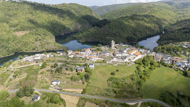 Aerial view of the historic town of Viana do Bolo nestled on a hilltop overlooking the winding river and lush green mountains Viana do Bolo, Province of Ourense, Spain.