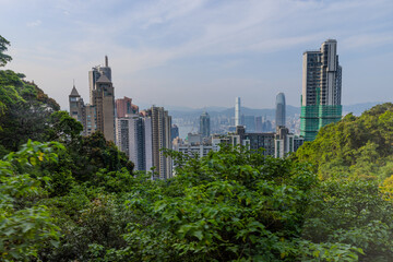 Obraz premium 20 April 2026 Down View of Residential and Commercial buildings and Victoria Harbour in Hong Kong HK in china. The Blue Skies and blue harbour is so Beautiful with view of Tsim Tsa Tsui commercial CBD