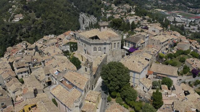 Aerial drone view of Haut de Cagnes hilltop village with Grimaldi Castle surrounded by dense terracotta rooftops and narrow streets in Cagnes sur Mer France