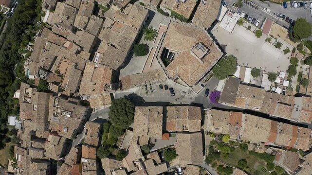 Aerial drone view of San Marino City old town with dense stone buildings and terracotta rooftops forming narrow streets and compact historic layout