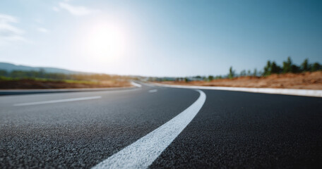 Obraz premium Curved asphalt road with clear sky