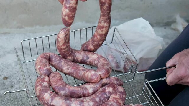 Close up of uncooked raw sausage showcasing its juicy texture, ideal for flavorful dishes and culinary creativity. black background. top view. High quality 4k footage