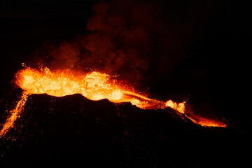 Aerial view into a volcanic crater spewing molten magma © Lukas Gojda