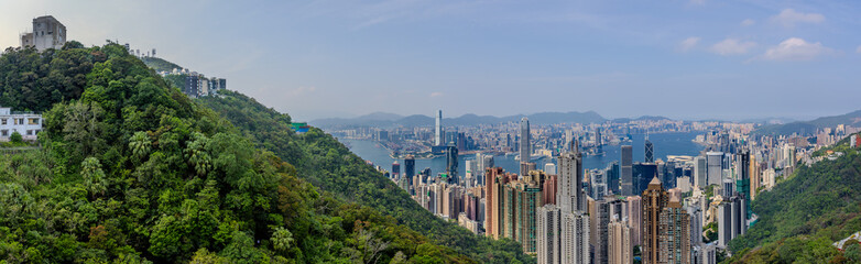 Fototapeta premium 20 April 2026 Down View of Residential and Commercial buildings and Victoria Harbour in Hong Kong HK in china. The Blue Skies and blue harbour is so Beautiful with view of Tsim Tsa Tsui commercial CBD