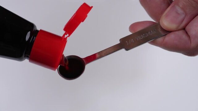 Pouring Soy Sauce into Quarter Teaspoon Measuring Spoon for Precise Cooking Measurement Concepts