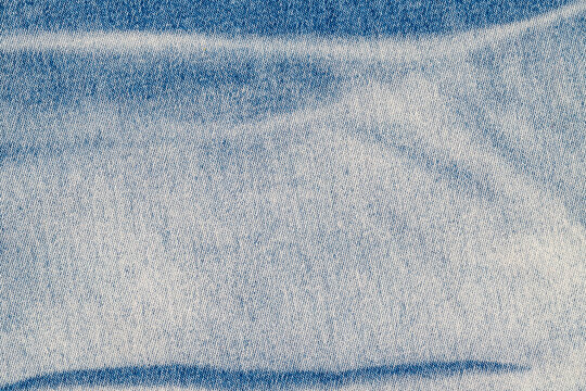 Close up view of light blue denim fabric showing texture and pattern in casual wear for clothing