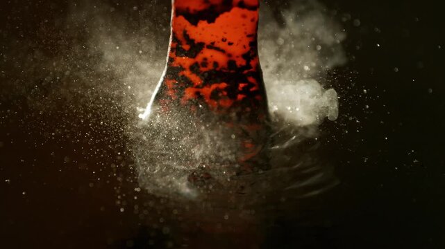 Blacksmith puts the red-hot forged metal part into the water . Super slow motion filmed on high speed cinematic camera at 1000 fps