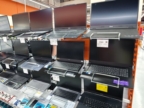 Sosnoviy Bor, Russia - April 30, 2026: Display of various laptops on shelves in an electronics store, showcasing different models and sizes with price tags visible