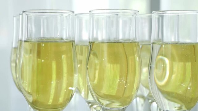 Close-up of a lot of champagne glasses on a table in a restaurant. Holiday, new year, wedding.