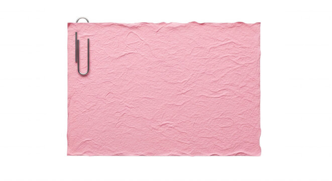 A rectangular sheet of textured pink paper with uneven edges, attached with a silver metal paperclip against a solid black background