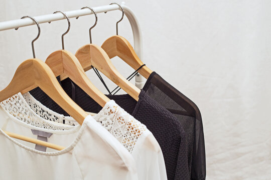 Clothes hanging on a rack show different styles and colors in a dressing area during daylight