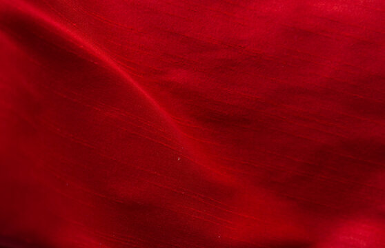 The red satin fabric ripples beautifully as a backdrop.