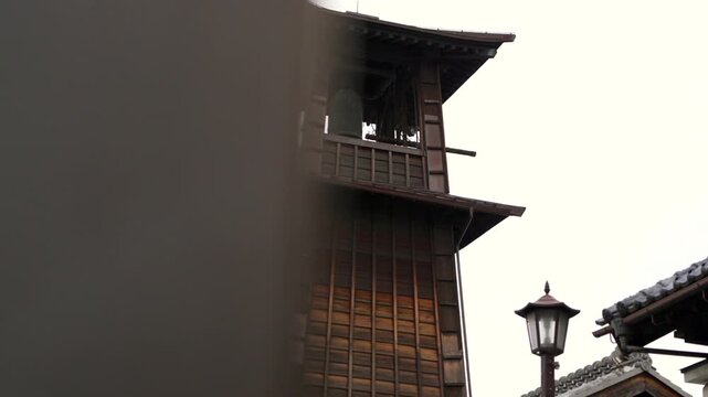 A panning reveal of the traditional wooden clock tower in Kawagoe, Japan, known as Toki no Kane.