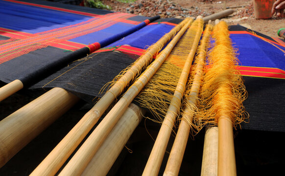 Handloom weaver in India working in loom.