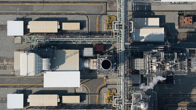 Aerial view of Amata B.Grimm Power Rayong 5 showing industrial structures, complex piping systems, and steam rising from the facility Map Yang Phon, Rayong, Thailand.