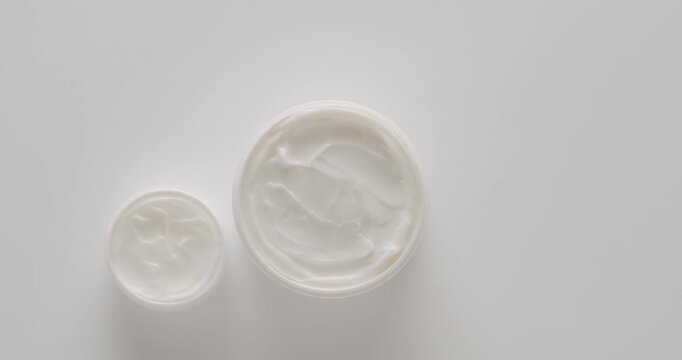 Cosmetics oils based on natural ingredients, scrub, tonic, body care. Group of different cosmetic bottles. Jars, bottles and tubes for cosmetics and Beauty treatment spin on a white background.