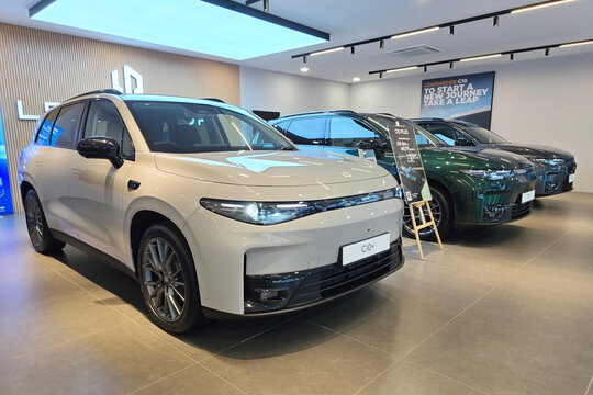 Bayan Lepas, Malaysia - Apr 7, 2026: A lineup of Leapmotor electric vehicles, including the C10 and C10 Plus models in various colors, displayed inside a brightly lit automotive showroom.