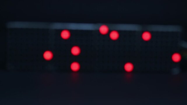 Movement of LED red in color my a matrix display with blurred background shows the concept of digital data movement